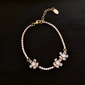 Gold geometric copper bracelet with zircon inlaid detailing and quadrilateral design elements