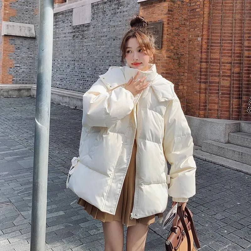 Women's loose black winter jacket with princess sleeves on a hanger.
