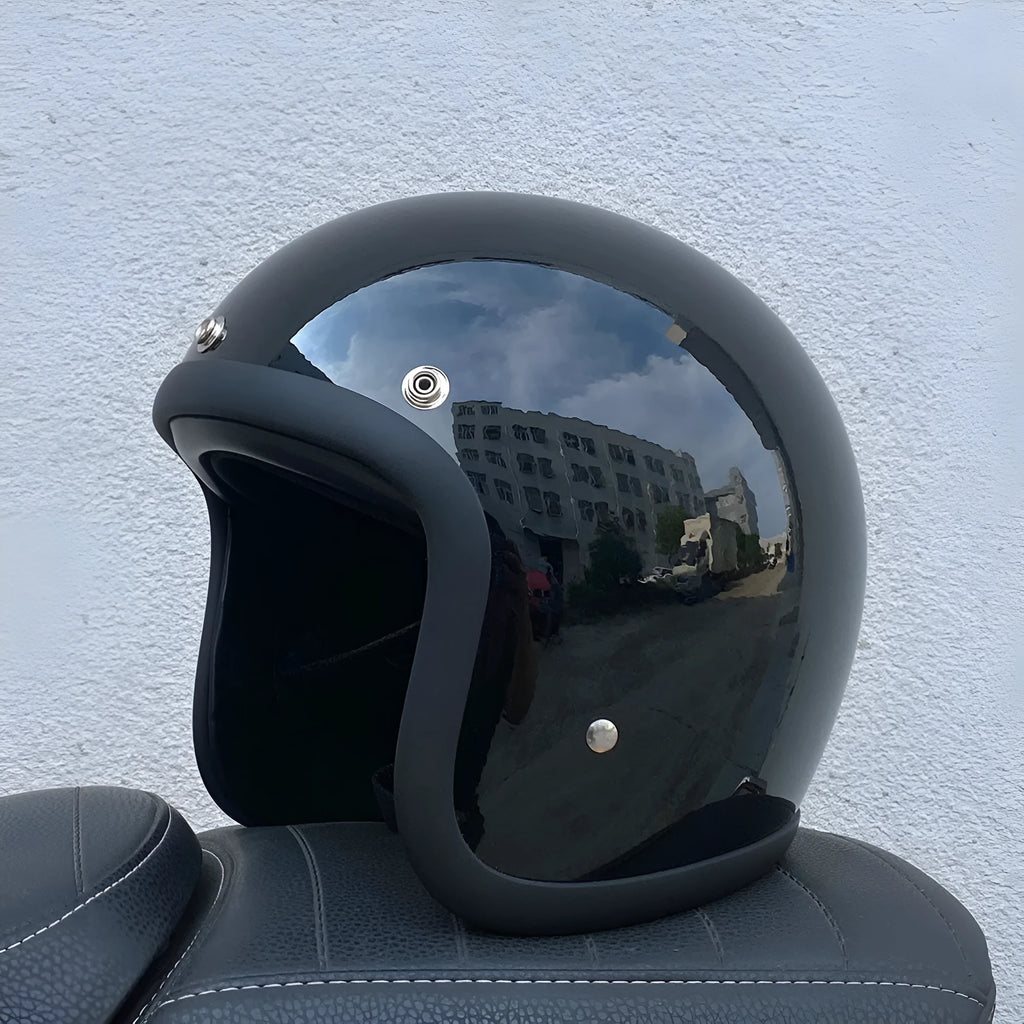 Retro-style open-face motorcycle half helmet in cement grey with a glossy FRP shell and quick-release chin strap.