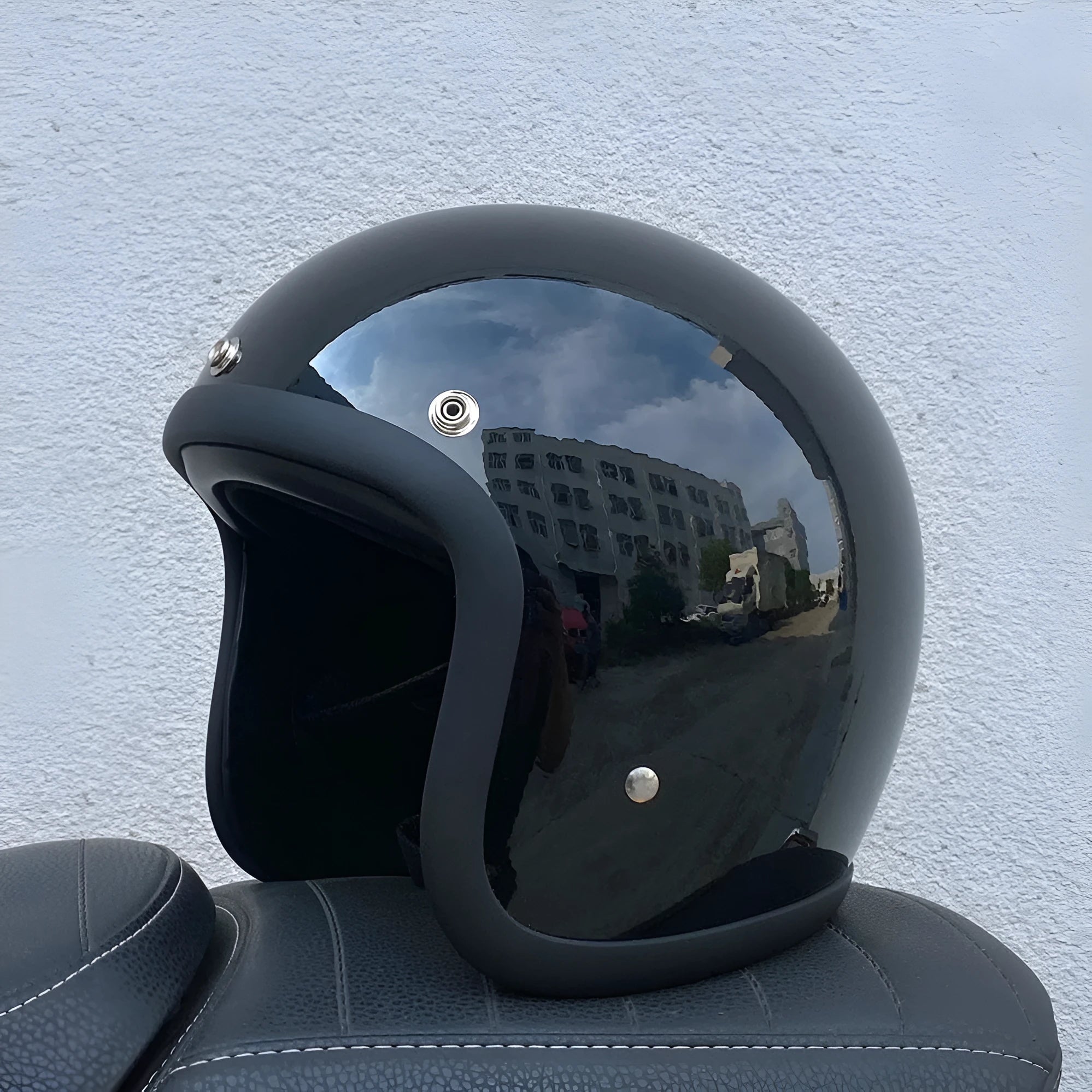 Retro-style open-face motorcycle half helmet in cement grey with a glossy FRP shell and quick-release chin strap.