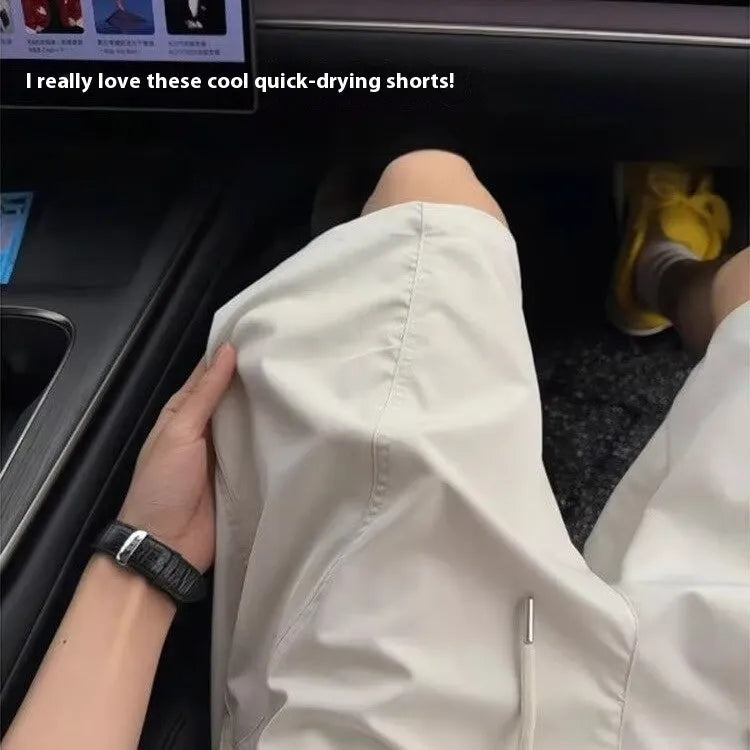 Men's quick-drying polyester sports shorts in creamy-white, straight leg cut with elastic waist.