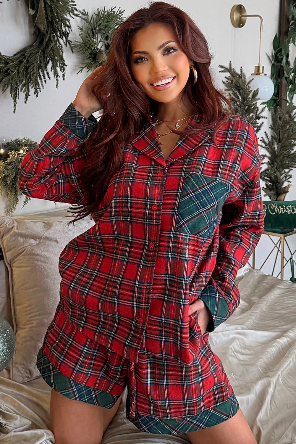 Red and black plaid adult pyjama set with long sleeve shirt and shorts on a hanger.