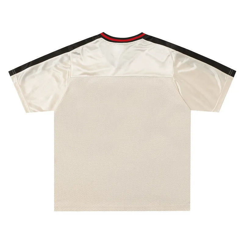 Apricot coloured V-neck sports jersey with short sleeves and letter pattern detail