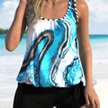 Blue tie-dye patterned women's two-piece swimsuit with separate top and shorts, shown on a hanger.