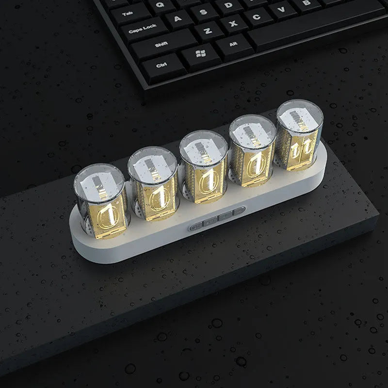 RGB Luminotron LED digital clock showing colourful display on desk with USB cable