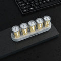 RGB Luminotron LED digital clock showing colourful display on desk with USB cable