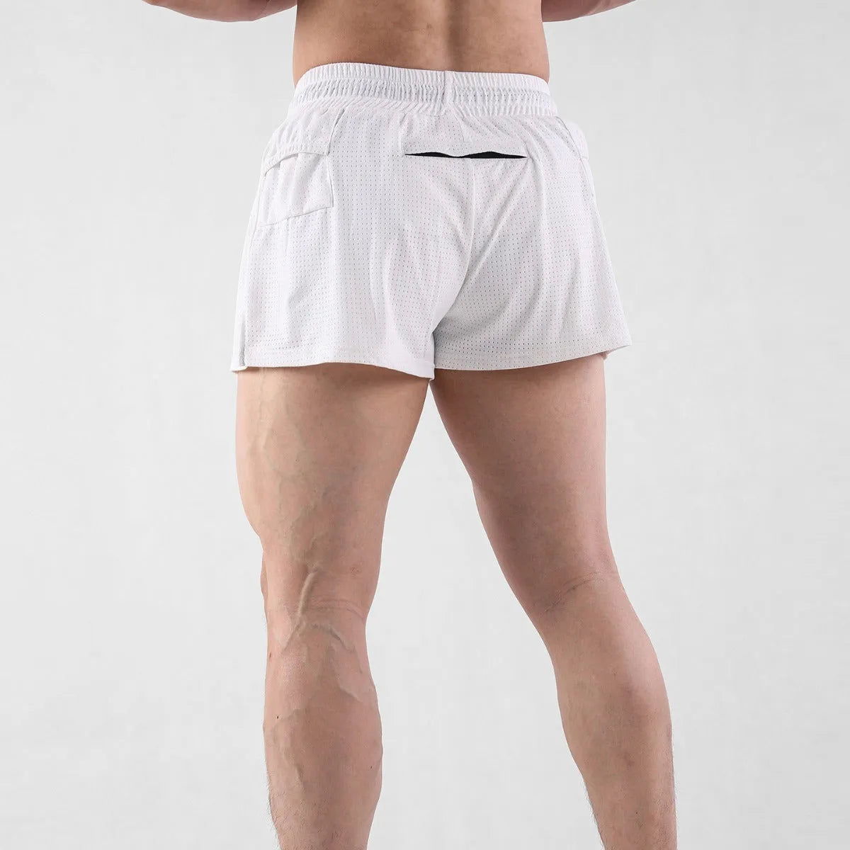 Men's white quick-drying nylon summer shorts laid flat, showing mid-waist design.