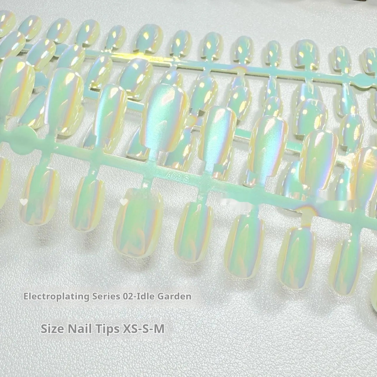 Set of electroplated Cat's Eye false nails in aurora armour style showing short ladder XS, S, and M sizes.