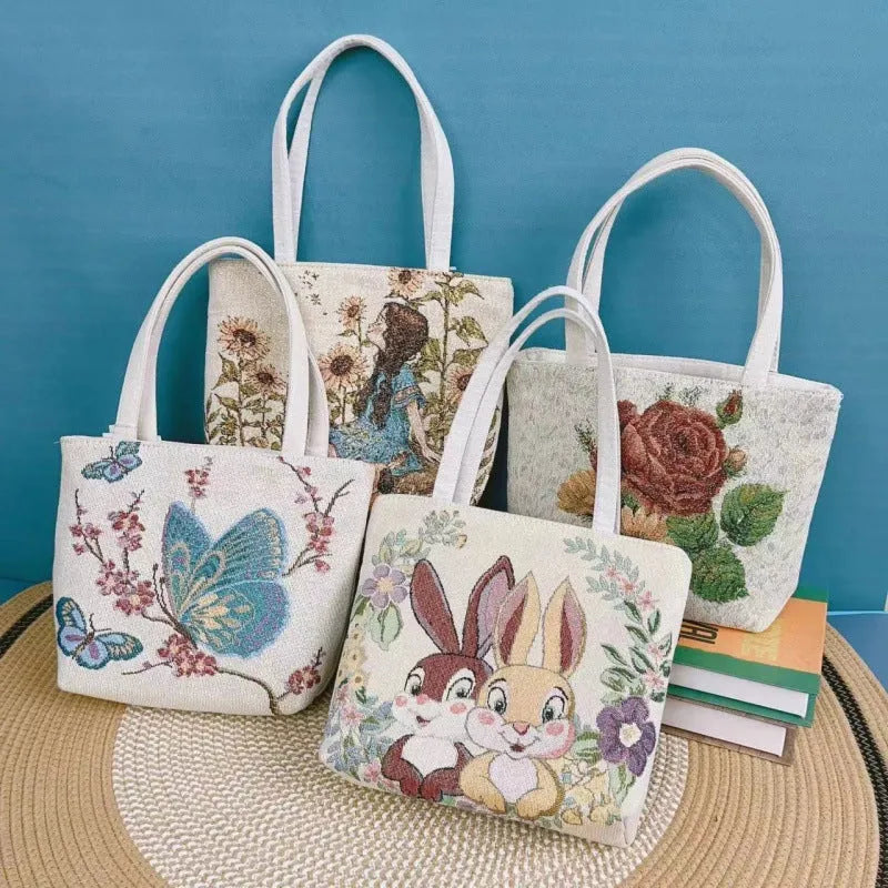 Double-sided gold wire embroidered canvas handbag in small, medium, and large sizes with patterned options.