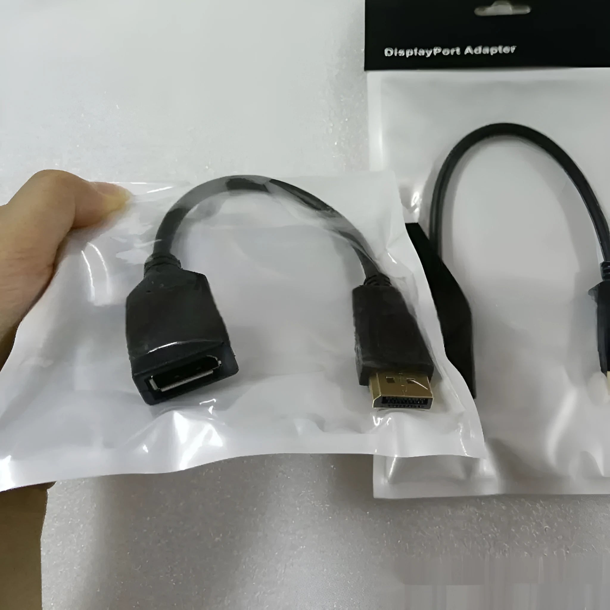 Black Display Port male to female extension cable measuring approximately 10cm in length.