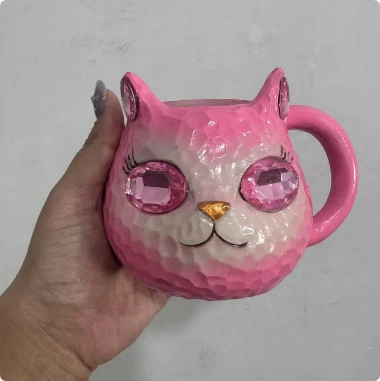 Resin cat cup ornament with crystal earth design in blue, green, pink, or purple colour options.