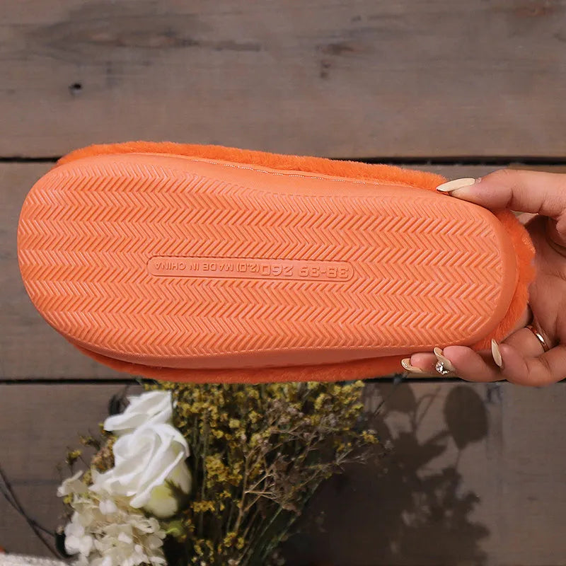 Orange Halloween pumpkin-themed plush indoor slippers with a non-slip PVC sole.