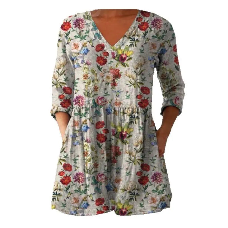 A loose-fitting women's dress with a wave print, 3/4 sleeves, and a wide waist.
