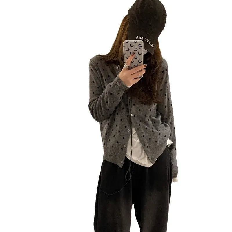 Women's grey dot print knitted cardigan with white crocheted flower detail on sleeve