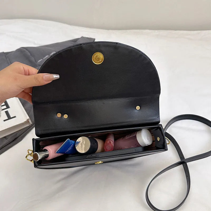Medium hard PU box saddle bag in solid colour with internal zipper pocket and oval shape