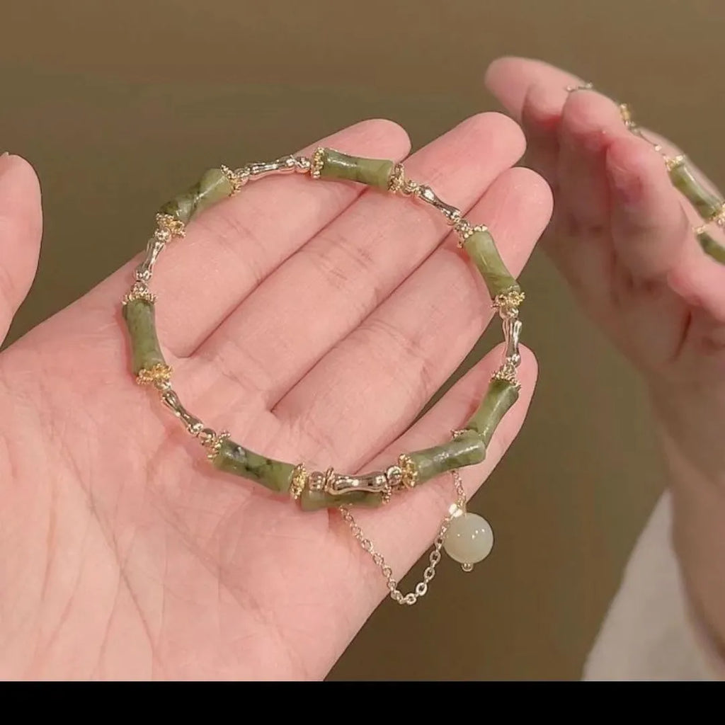 Women's bamboo bracelet with coloured glaze beads and a plum wine coloured bamboo joint centrepiece.