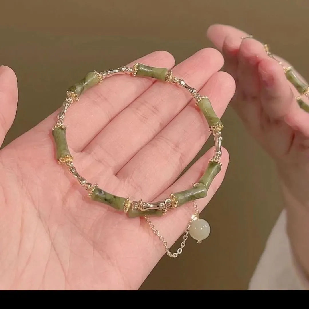 Women's bamboo bracelet with coloured glaze beads and a plum wine coloured bamboo joint centrepiece.