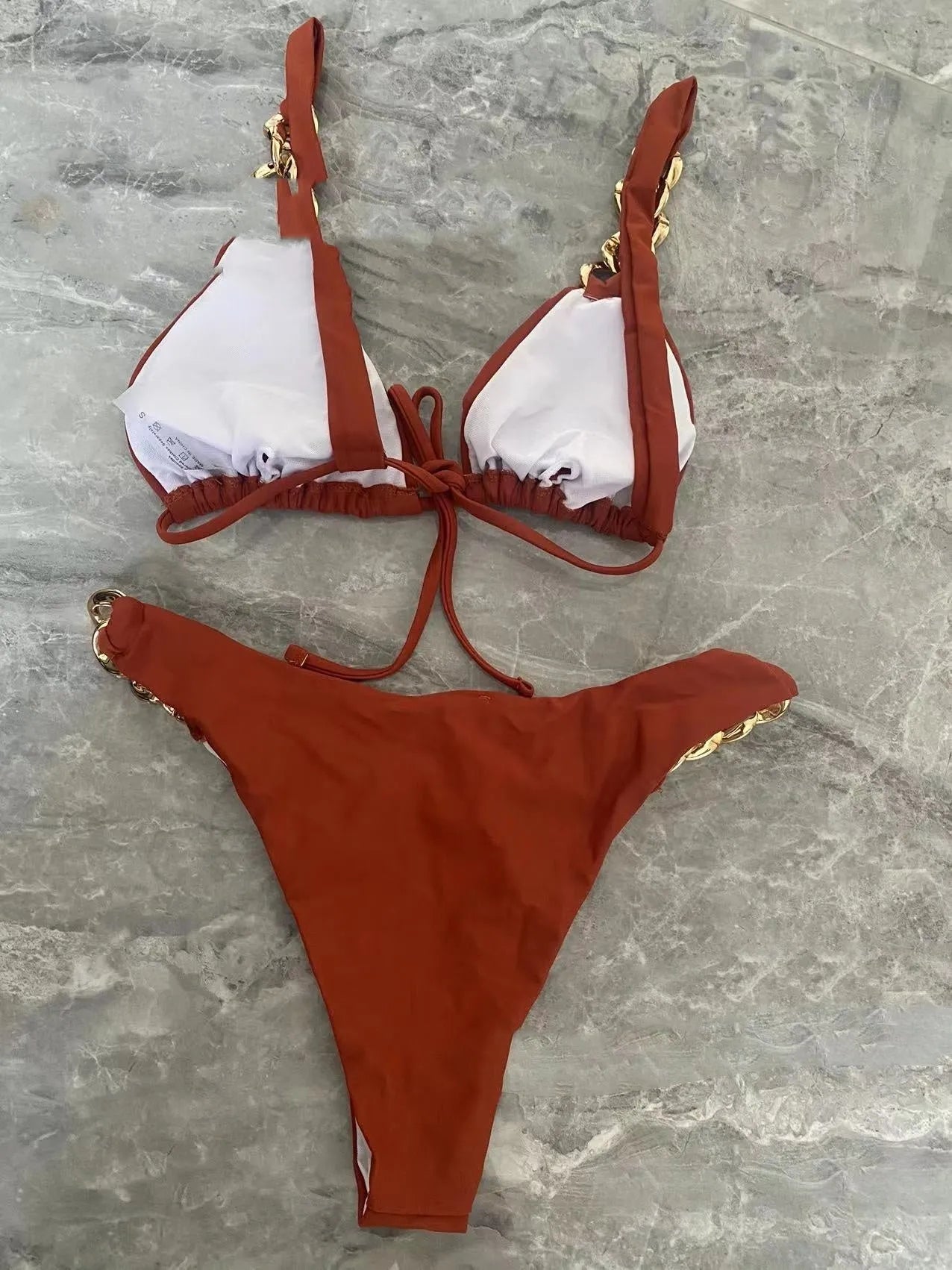 Brown women's tube-top bikini with adjustable metal rings on the back and a split-leg bottom.
