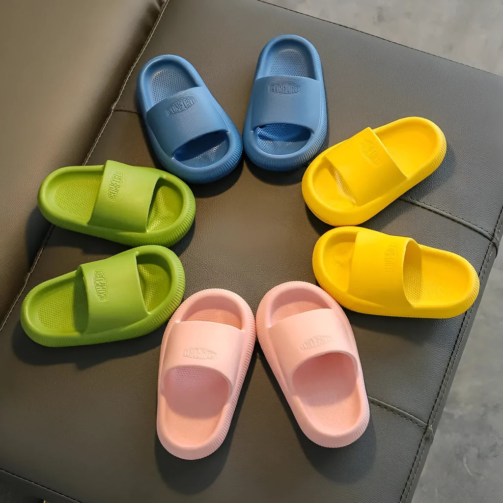 Children's mixed colour EVA slippers with textured non-slip soles and 1.5cm thick cushioning.