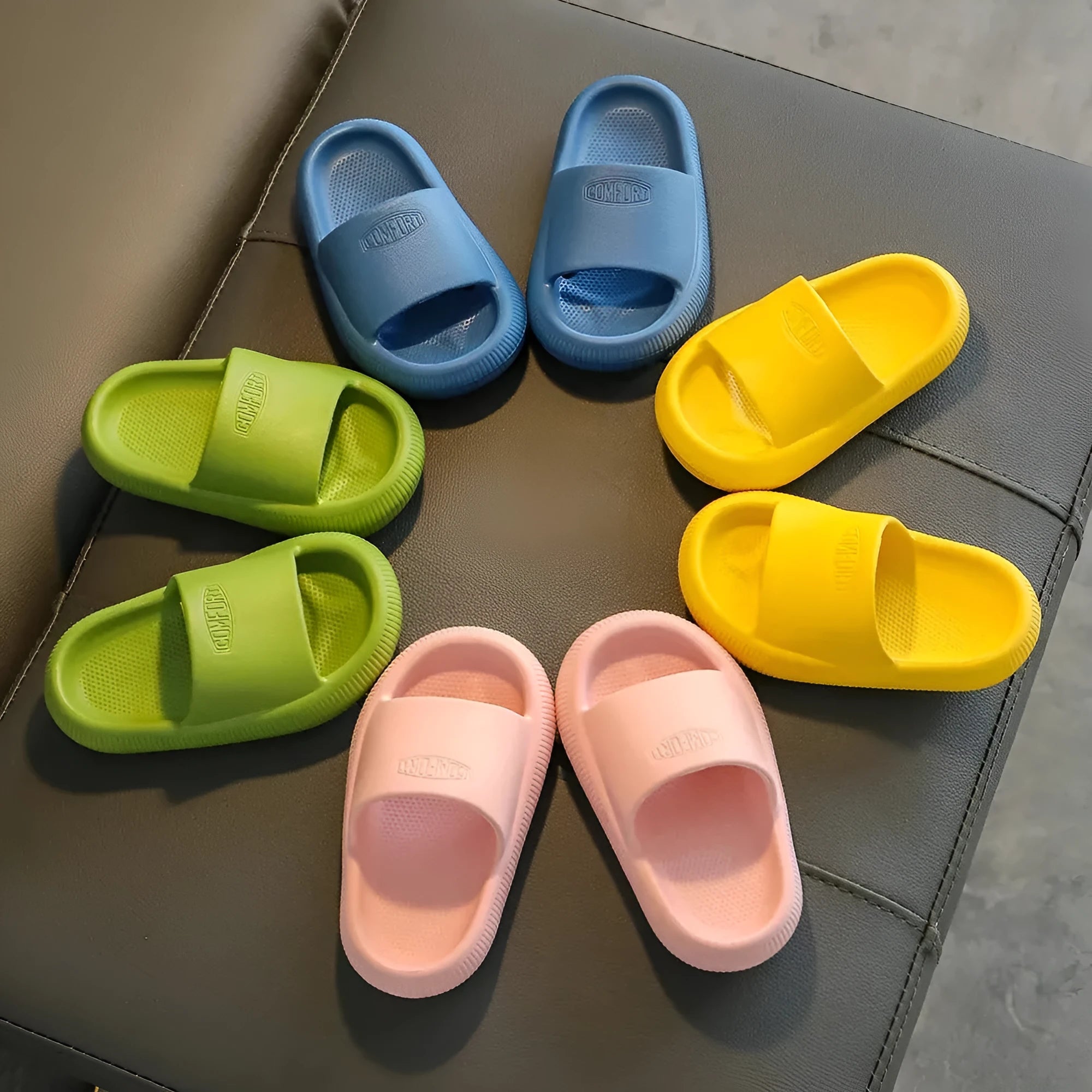 Children's mixed colour EVA slippers with textured non-slip soles and 1.5cm thick cushioning.