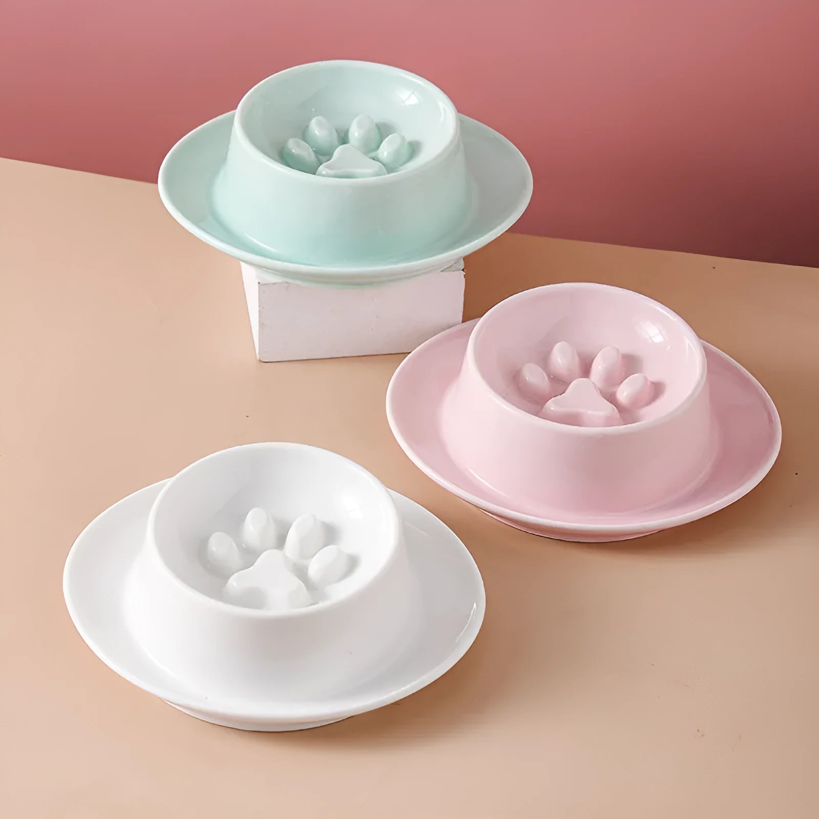 Green ceramic anti-choking slow food bowl for cats and dogs on a flat surface.
