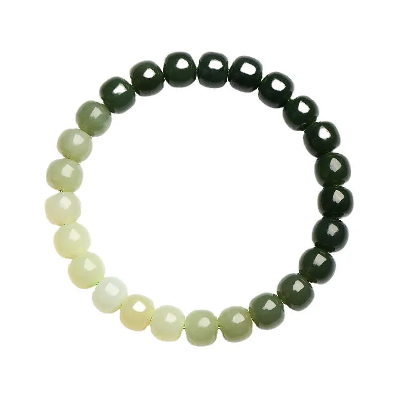 Natural Hetian jade bracelet with gradient clear water colour on a wrist.
