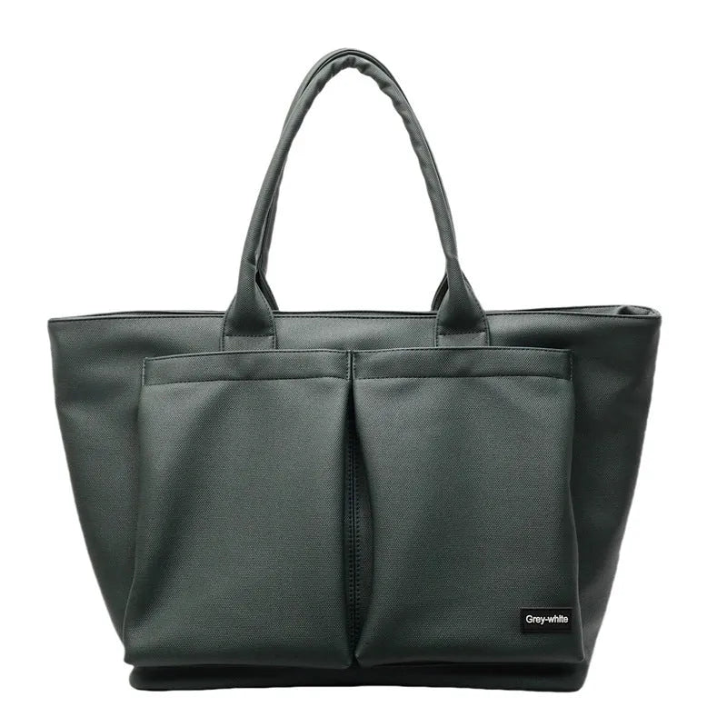 Lightweight expandable PU shoulder bag shown in solid green colour with ventilation panel