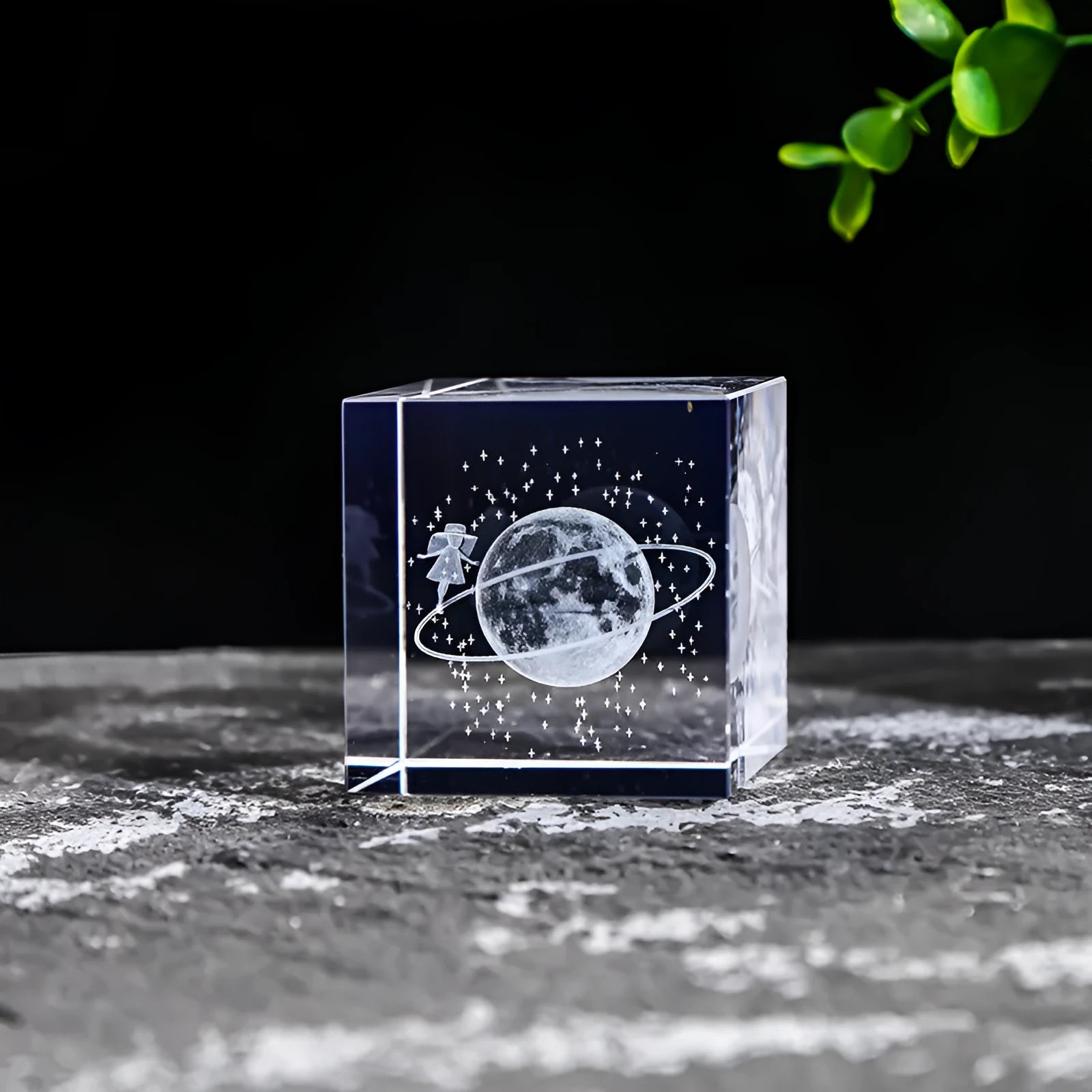 White crystal square ornament with engraved lotus design on a desk surface