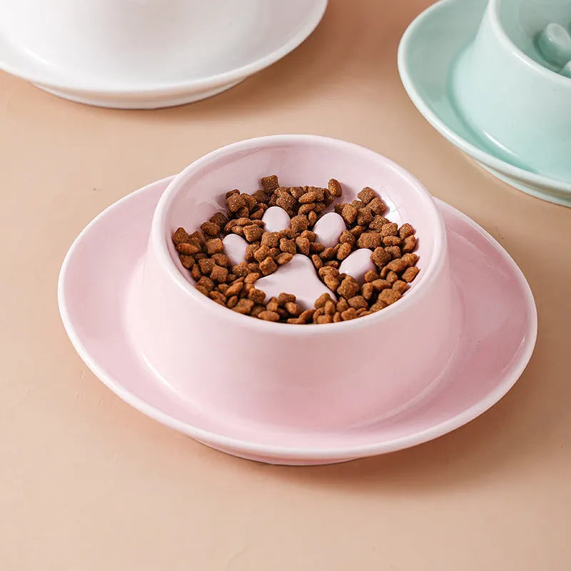 Green ceramic anti-choking slow food bowl for cats and dogs on a flat surface.
