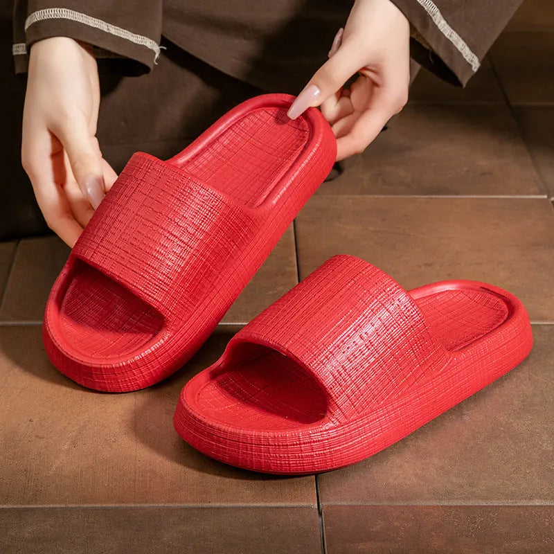 Pair of EVA toe ring flip flop slippers on a wet floor, showing non-slip sole pattern.
