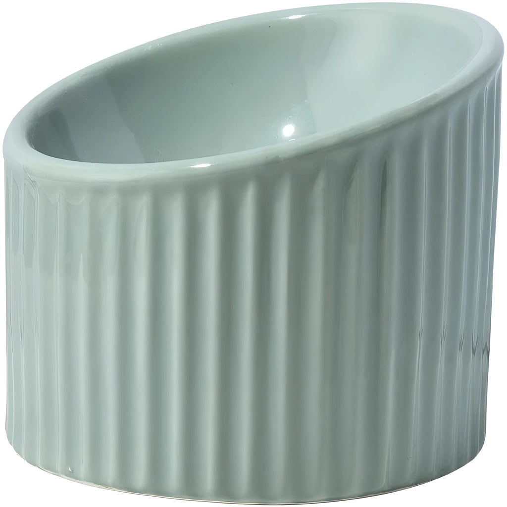 Ceramic elevated cat food bowl in green, showing tilted round dish on a raised stand.