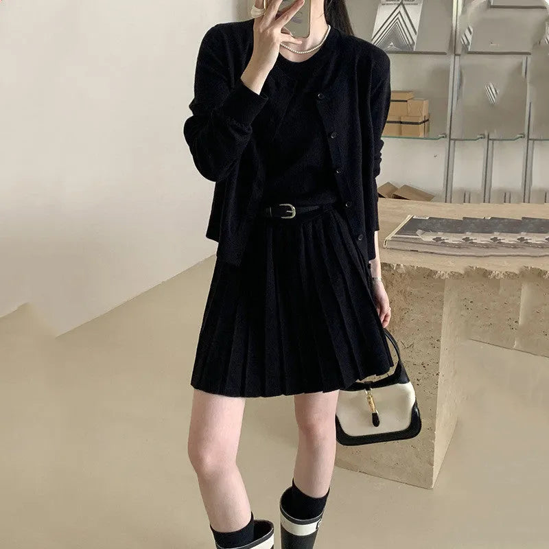 Women's grey Art Retro knitted set with 3D pattern, featuring a pleated midi skirt and long-sleeve cardigan.