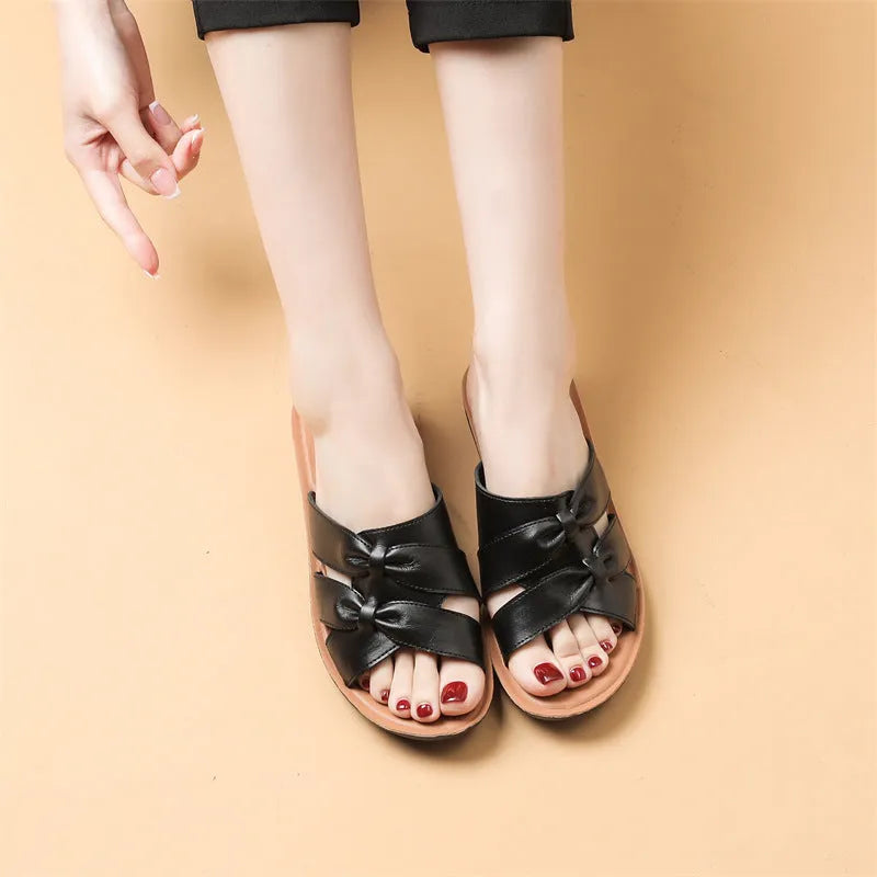 Beige cowhide women's slipper sandals with a non-slip sole, shown from the side.