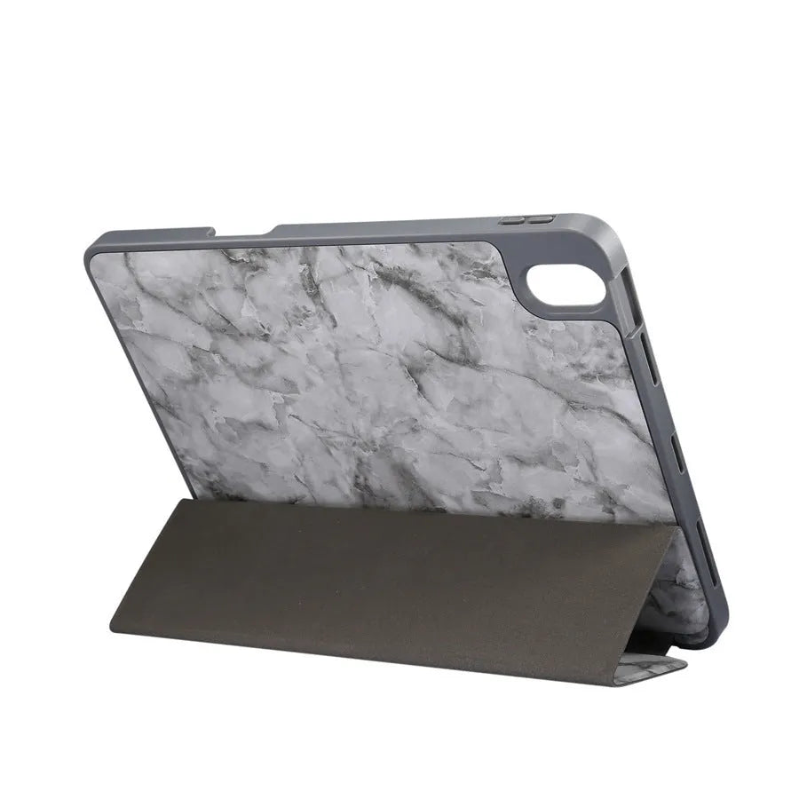 Marbled tri-fold iPad case in dark grey standing upright, showing pen slot and folded stand.