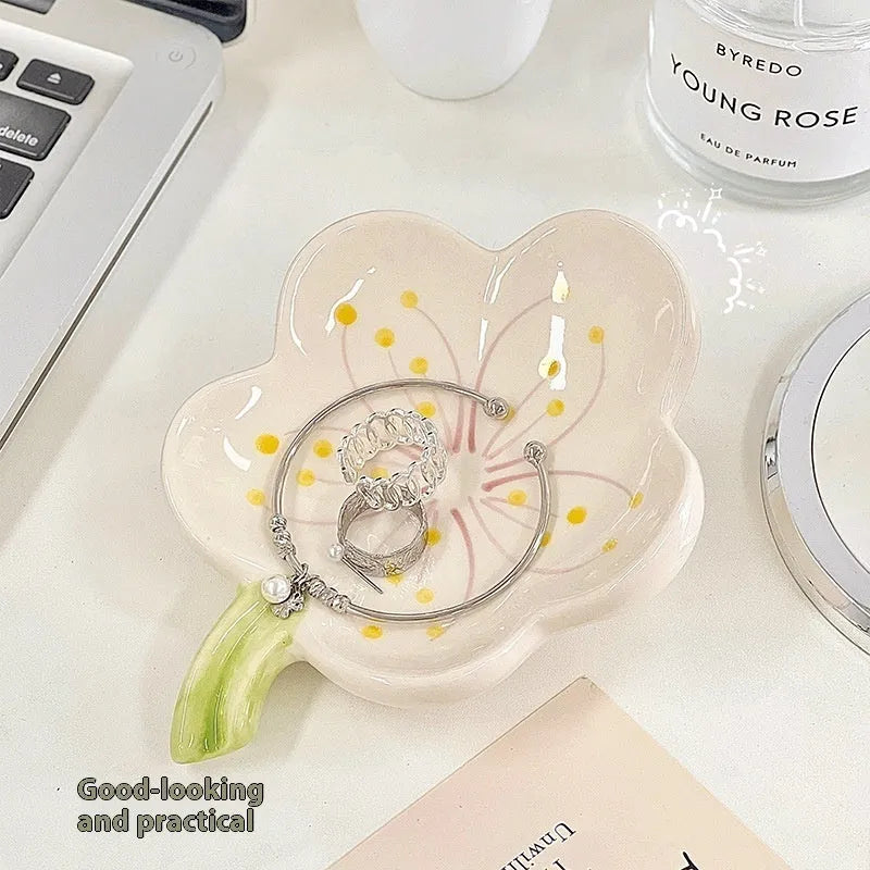 White porcelain decorative shell-shaped tray with a matching small night lamp on a wooden surface.