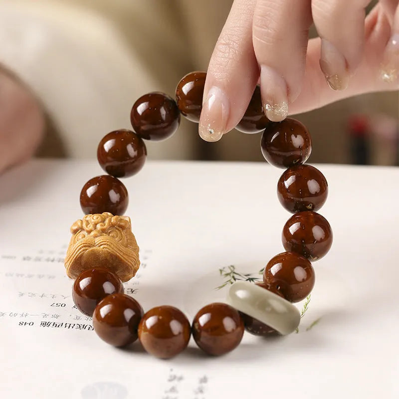 Hand-woven 13mm round bead bracelet with artistic lion designs in ivory nut, sandalwood or yellow gradient bodhi colours