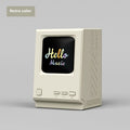 Retro small computer lyrics speaker table clock wireless Bluetooth speaker in pink purple colour on a desk