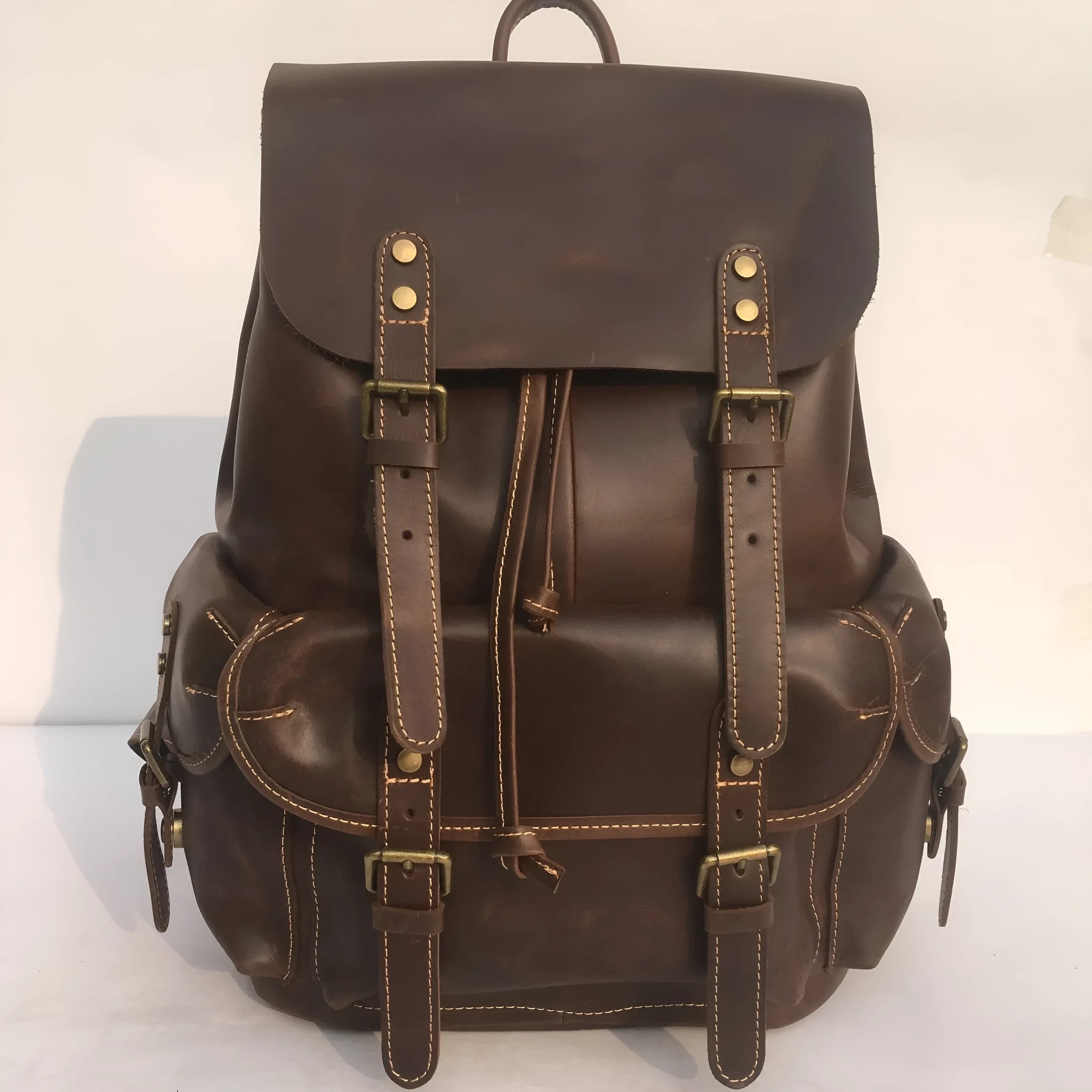 Brown coffee genuine leather men's backpack with air cushion shoulder straps showing first layer cowhide texture