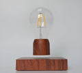 Magnetic levitation floating light bulb with imitation wood base.