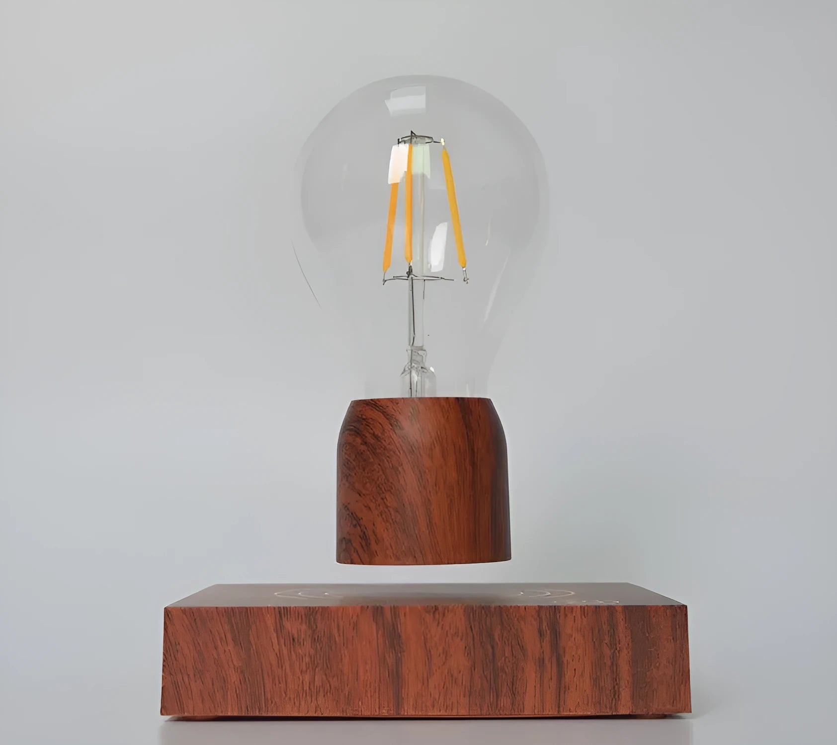 Magnetic levitation floating light bulb with imitation wood base.