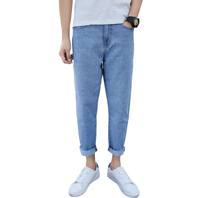 Men's loose straight-leg high-waisted harem jeans in black, laid flat.