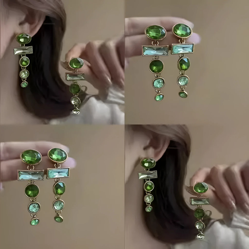 Green gradient geometric alloy earrings with a long tassel and sparkling inlaid zircon centre on a white background.