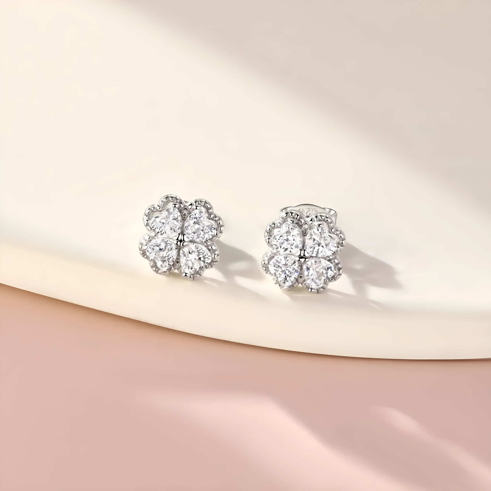 Close-up of women's heart-shaped zircon earrings in 925 silver with a white gold colour finish.