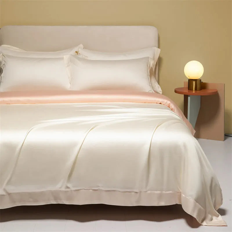 Aurora Blue 200 thread count Tencel duvet cover, fitted sheet, and pillowcases laid on a modern bed.