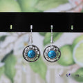 Handmade Miao silver geometric flower disk earrings with turquoise in red, blue, or black.