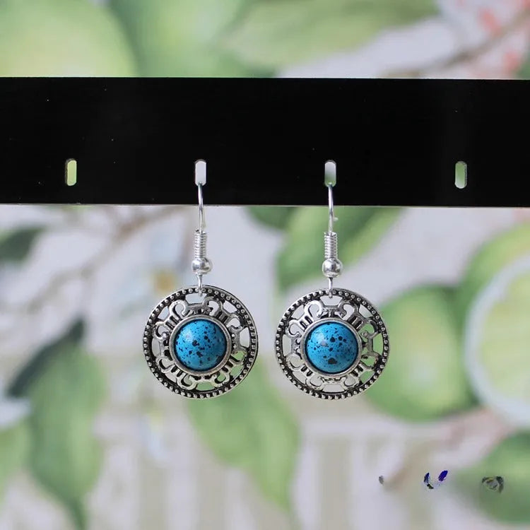 Handmade geometric ethnic earrings in Tibetan silver and turquoise with totem patterns.