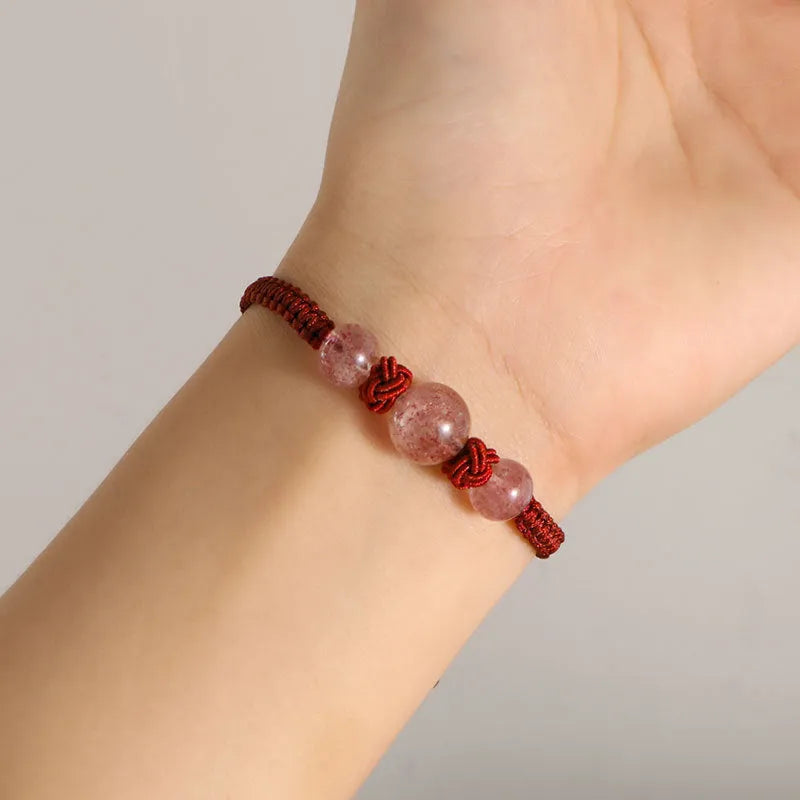 Red woven rope bracelet with spherical strawberry quartz beads and alloy accents