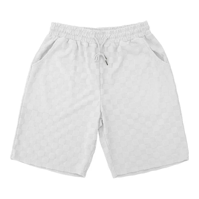 Men's loose-fitting checkerboard plaid sports shorts in micro-elastic polyester, shown in a neutral colour.