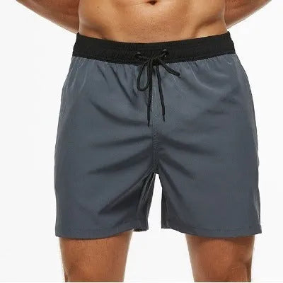 Men's blue polyester active shorts with a drawstring waist and zipper pocket.