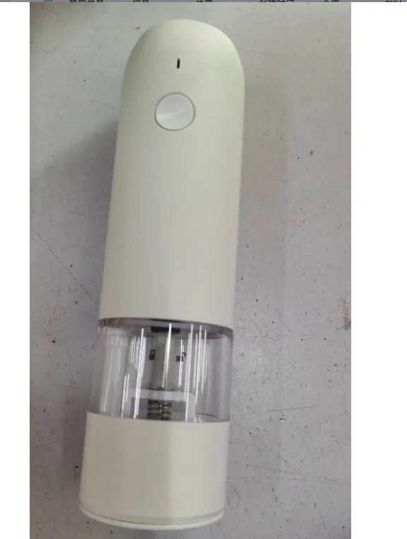 Black and silver electric pepper and salt grinder set with clear acrylic body on a kitchen counter.